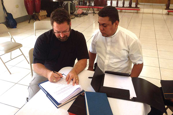 Rev. Dr. Albert Collver and President Marvin Donaire sign the protocol agreement.