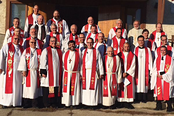 CAPTION: LCC’s Interim Pastoral Leader for Alberta and British Columbia Nolan Astley (third from left in front), ABC District President Glenn Schaefer (fourth from left in front), and LCC President Robert Bugbee (fifth from left in front) pose with the many pastors taking part in the joint Installation-Commissioning service in Edmonton.