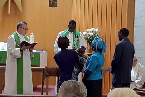 Tesloch Taydor is baptized, with his grandparents Martha and Moses serving as sponsors.