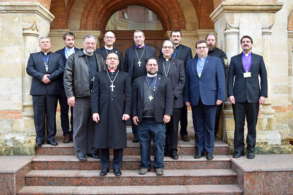 Back: Bishop Alexander Yurchenko (SELCU), Vice President Oleg Schewtschenko (SELCU), Rev. Daniel S. Johnson (LCMS-SELC), Bishop Mindaugas Sabutis (LELB), Rev. Olav Panchu (ELCIR), Valera Partizan (DELKU). Front: President Matthew C. Harrison (LCMS), Bishop Serge Maschewski (DELKU), Rev. Dr. Albert Collver (LCMS), President Robert Bugbee (LCC), Rev. Andris Kraulin (ELCL), Bishop Vsevolod Lytkin (SELC).