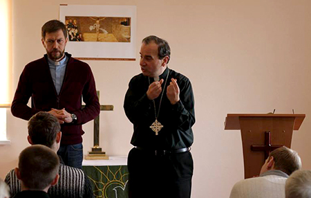 LCC President Bugbee lectures at SELCU's seminary, while Rev. Alexey Navrotskyy translates.