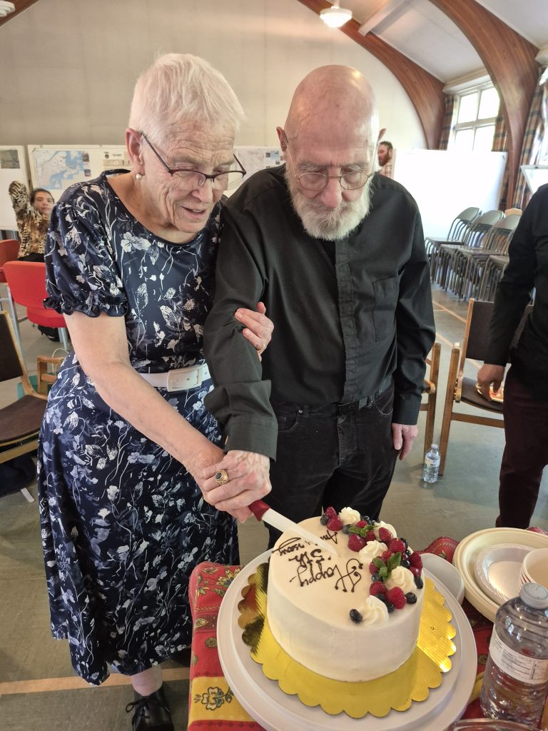 Rev. Frank and Nancy Morgret cut anniversary cake.