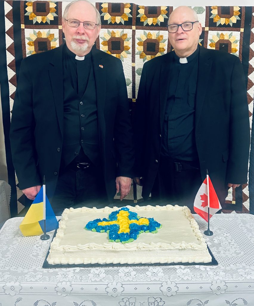 Rev. Dr. William Mundt stands beside West Regional Pastor Robert Mohns in front of a cake, during the celebration of Dr. Mundt’s 50th ordination anniversary at St. Paul’s Lutheran Church in Chilliwack, B.C.