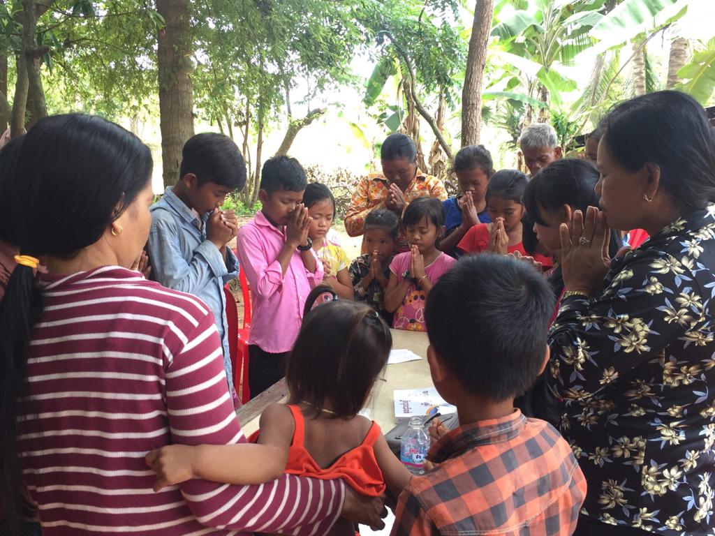 Women and children gathered in prayer.
