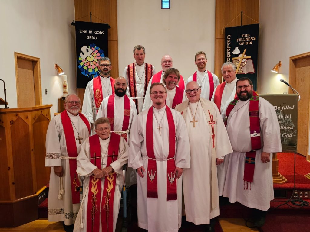 Pastors in red vestments at installation service.