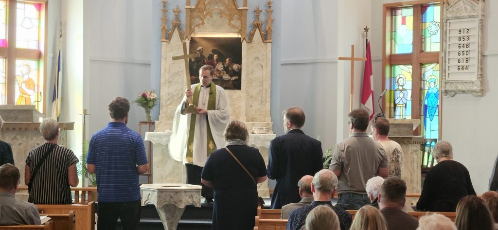 LCC Central Regional Pastor David Haberstock leads the rite of deconsecration while bearers stand ready to receive items.